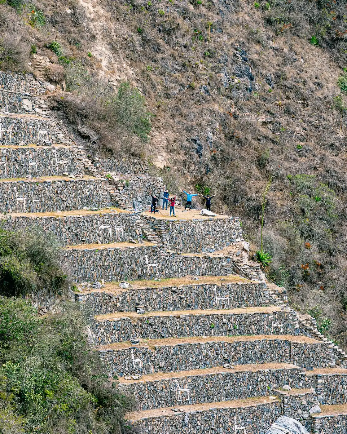 Stone terraces at Choquequirao decorated with white stone llama figures