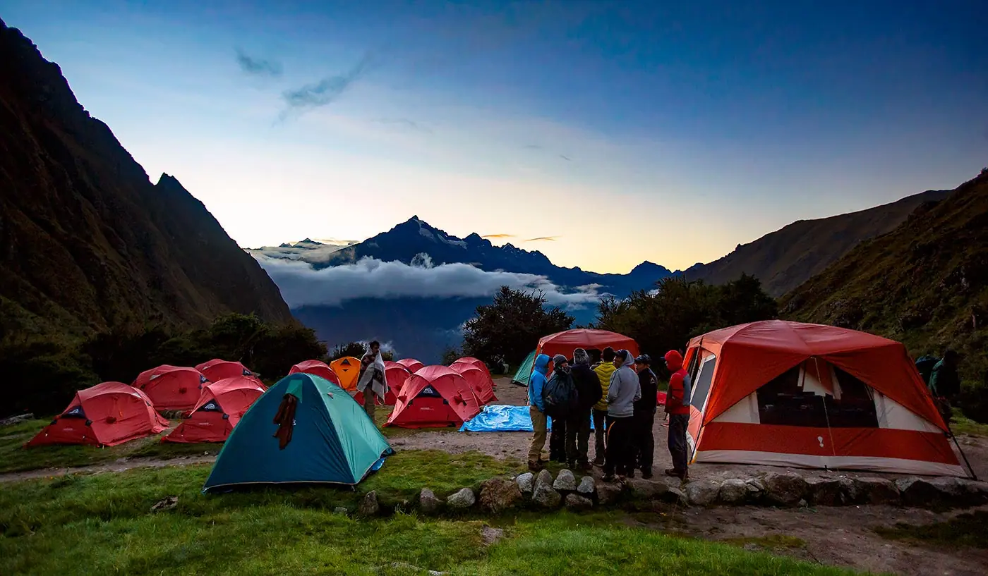 Tents at an Inca Trail campsite below Andean peaks