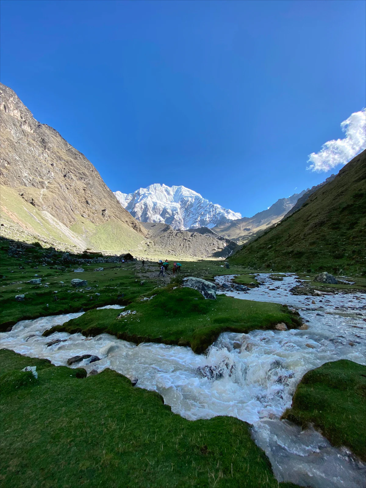 Snowcapped Salkantay above a high valley and glacial stream on the Salkantay route
