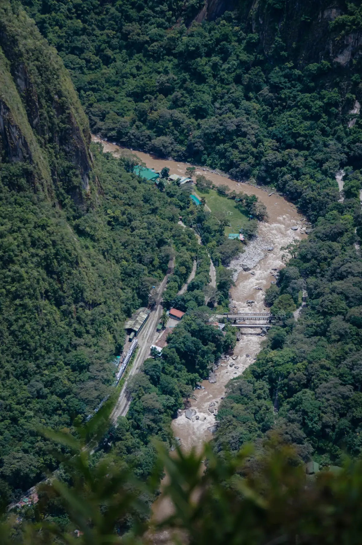 The Urubamba River and the railway winding through cloud forest below Machu Picchu